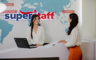 A SuperStaff specialists talks with a prospective client about recruitment process outsourcing.