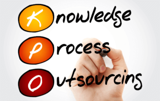 A hand holding a pen pointing to the words, knowledge process outsourcing.