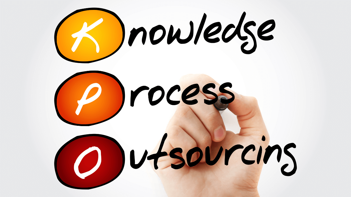 A hand holding a pen pointing to the words, knowledge process outsourcing.