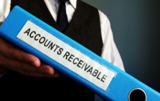 A man holding a folder labeled accounts receivable.