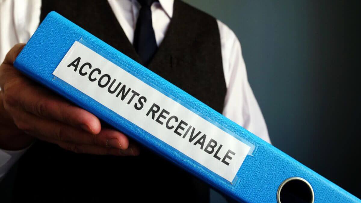 A man holding a folder labeled accounts receivable.