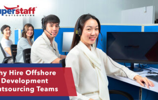 Four of SuperStaff's AI development outsourcing team are busy working with their computers.