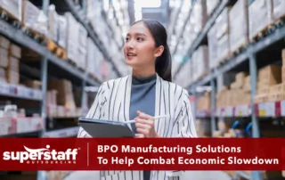 An executive checks warehouse to determine how BPO manufacturing solutions can help the business.