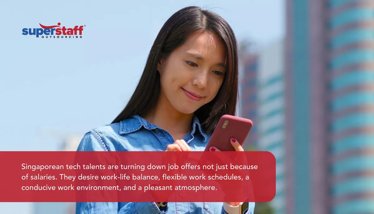 An image shows a woman looking at her phone and captions explaining why there's widespread Singapore labor shortage.