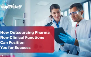 Two pharmaceutical executives work in the laboratory. Image caption says outsourcing pharma non-clinical functions can make firms successful.