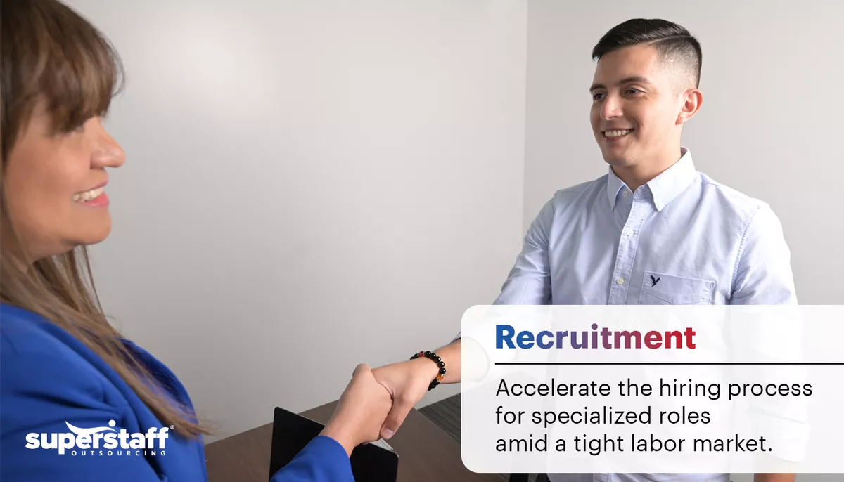 A recruiter shake hands with an applicant. Recruitment process outsourcing is one tasks when outsourcing pharma functions from a BPO.