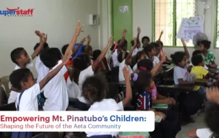 Aeta kids are inside the classroom, raising hands to answer a question.