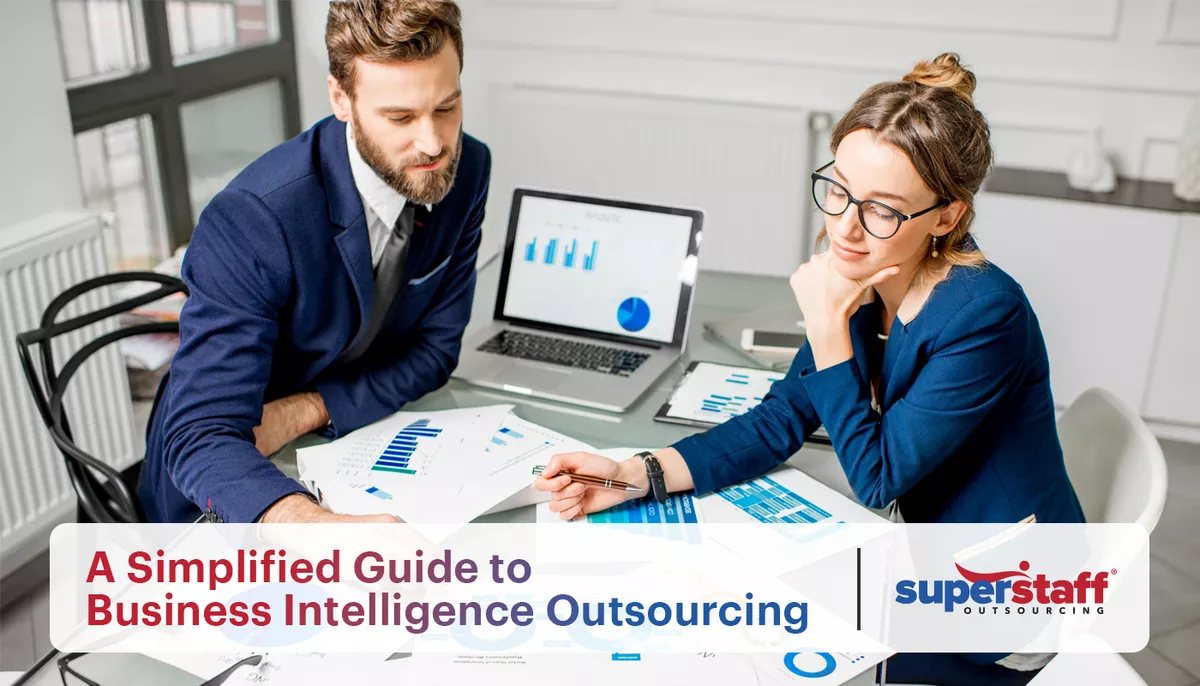 An image showing two data experts discussing graphs. The title of the blog "Decoding Data Excellence: A Simplified Guide to Business Intelligence Outsourcing" is also on the image.