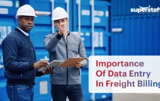 The image shows two male freight workers discussing something in their workplace. It also shows the text "Precision Matters: The Vital Role of Accurate Data Entry in Freight Billing."