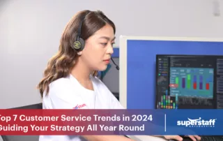 A photo shows a SuperStaff agent working on her computer. Image caption says: Customer Service Trends 2024