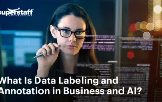 The image shows a data scientist is deep in work. It also shows the title of the blog, "What Is Data Labeling and Annotation: The Backbone of Business Analytics and AI Training."