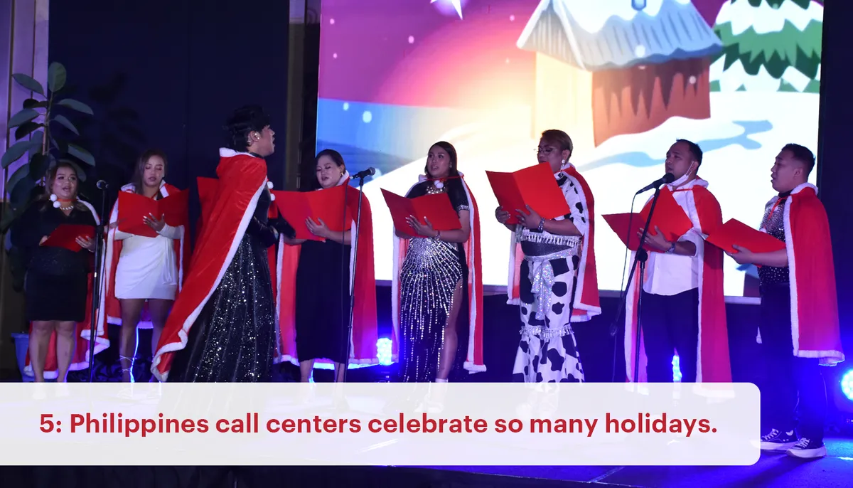 A group of employees wear Santa costume while singing, performing a Christmas song as part of call center Philippines holiday celebration.