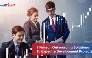 Three bank professionals look at charts and documents. Image caption says: 7 Fintech Outsourcing Solutions To Expedite Development Projects