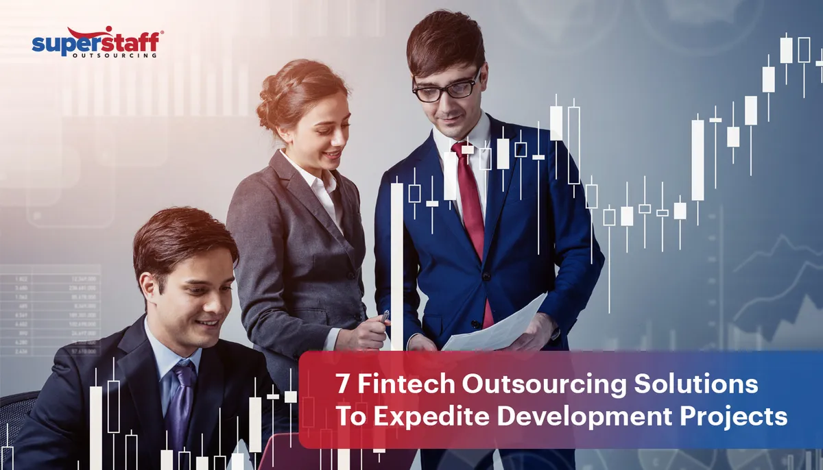 Three bank professionals look at charts and documents. Image caption says: 7 Fintech Outsourcing Solutions To Expedite Development Projects
