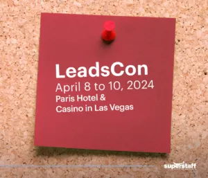 A post-it shows schedule of LeadsCon, a B2B sales conference.