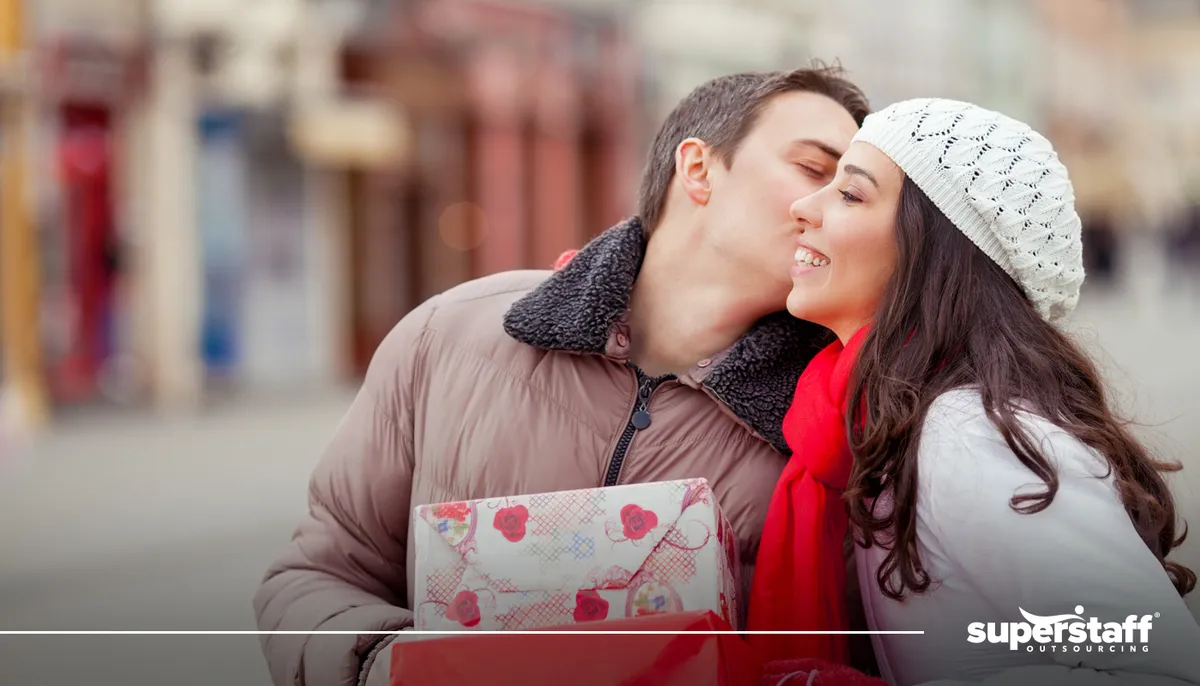 A phot shows a man kissing a girl on the cheek.