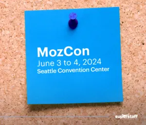 A post-it shows MozCon schedule, a B2B sales convention.