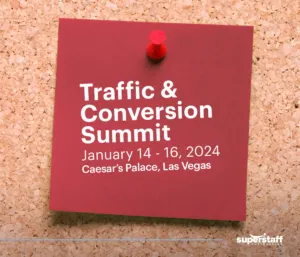 A post-it shows schedule of Traffic & Conversion Summit, a B2B sales conference.