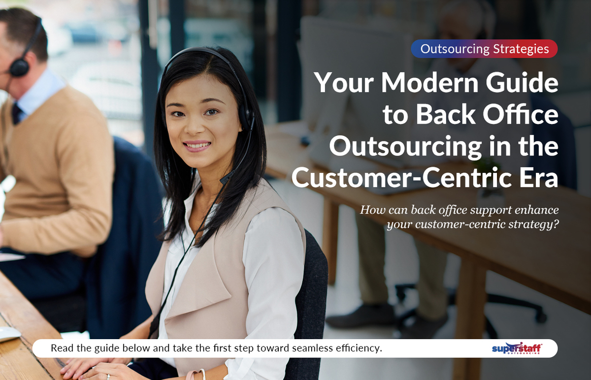 A back office outsourcing specialist smiles while working.