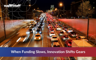 Nighttime traffic on a busy city highway with blurred motion effects, symbolizing how the impact of funding cuts on transportation is driving innovation and operational shifts in 2025.
