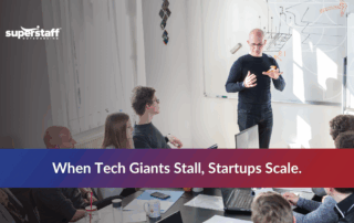 Startup team meeting with “Startups Scale” message