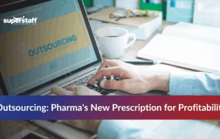 Hand on laptop with about outsourcing pharma