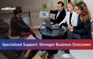 Business team collaborating on industry-specific solutions during a meeting in a modern office space.